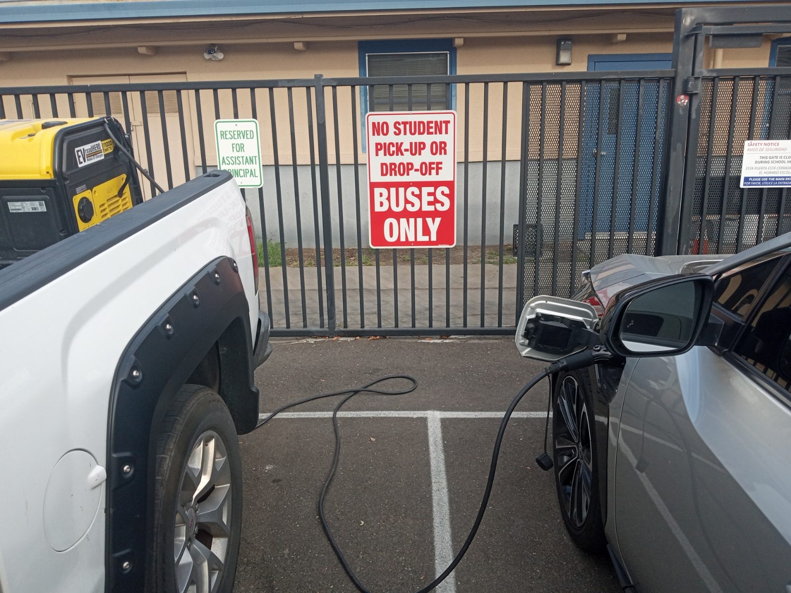Silver Toyota EV charging in a school parking lot from a truck-mounted EVroadHERO mobile charger